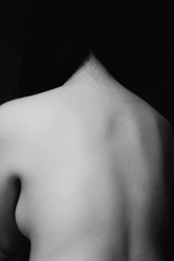 black and white pograph of woman back with no skin