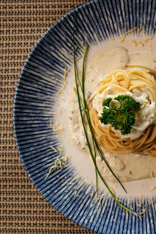 a plate with a small portion of spaghetti and broccoli