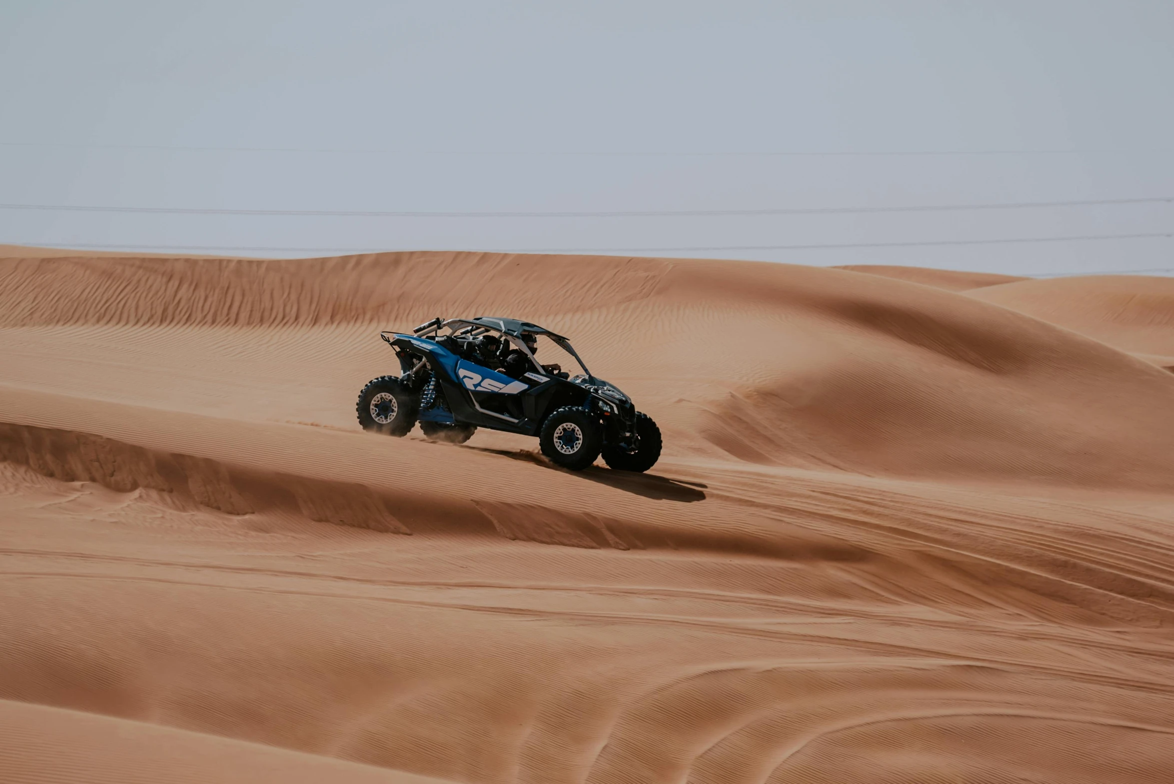 a person riding a four - wheeler through the desert