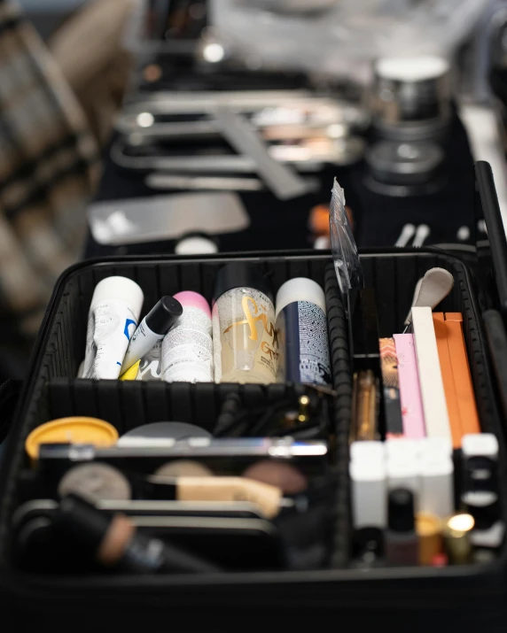 two open travel makeup cases with tools in it