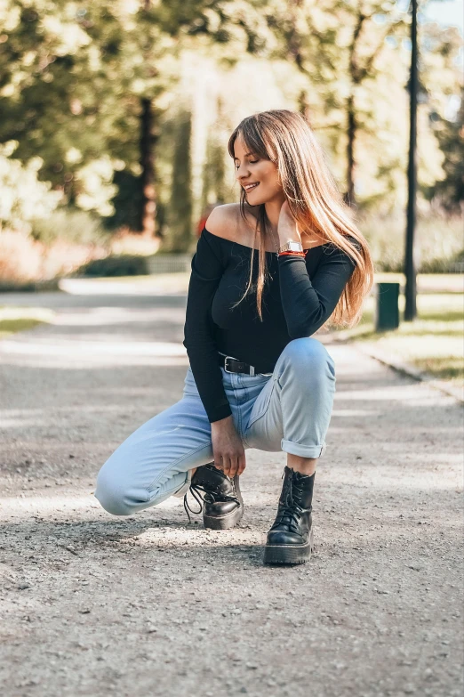 a girl in black is posing for a picture