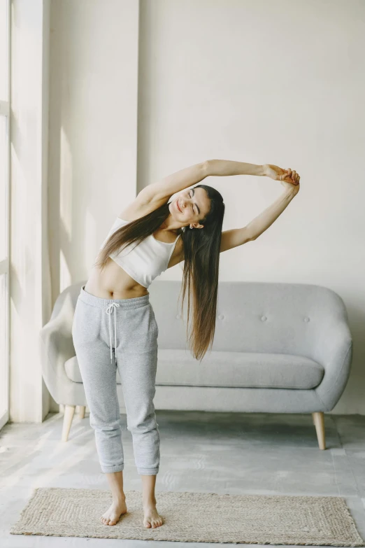 a girl stretching and smiling with arms crossed