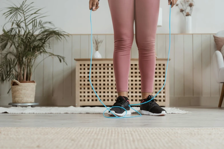 a person using a pair of blue and black exercise ropes