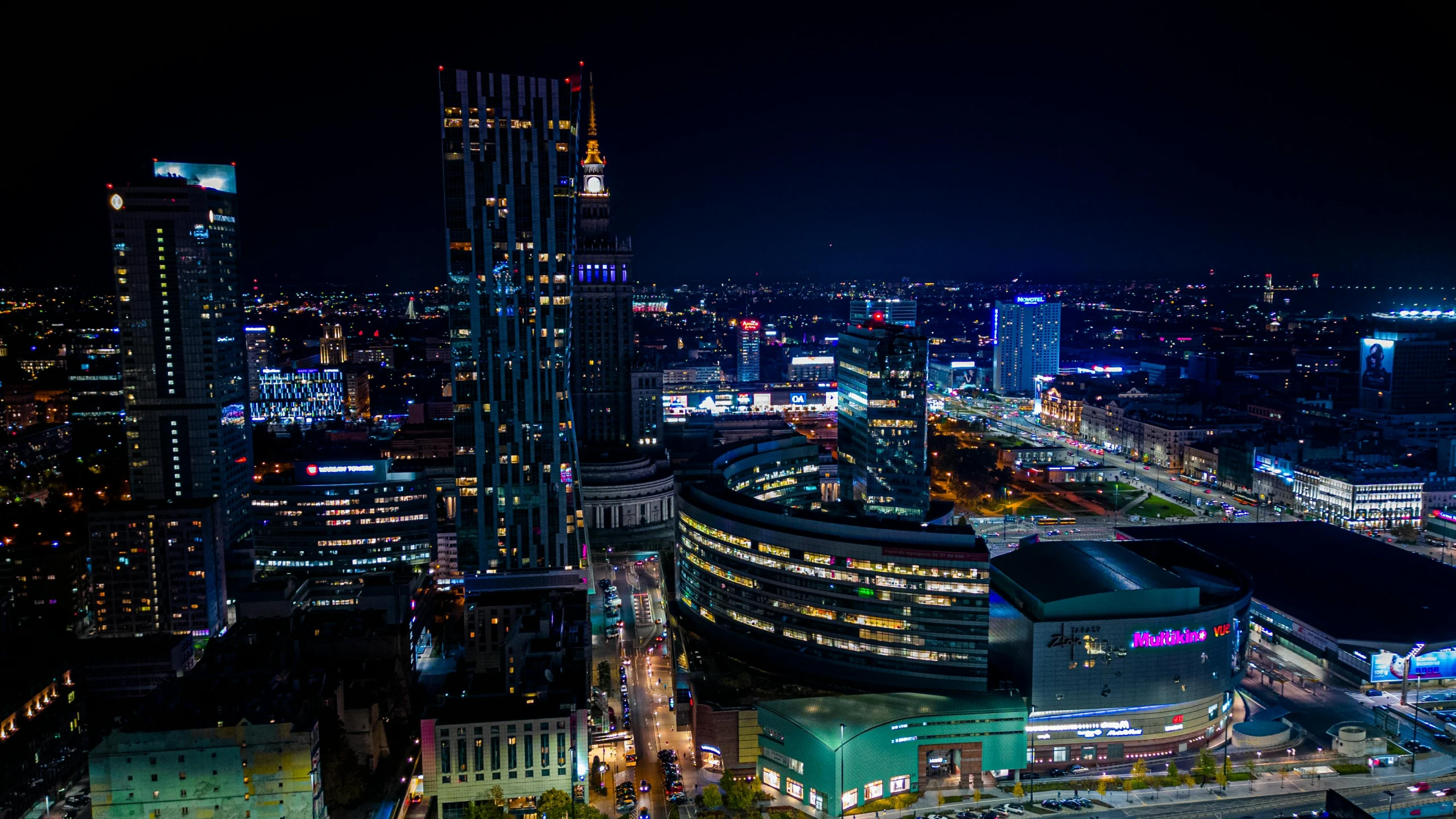 a nighttime view of a large city with lots of buildings