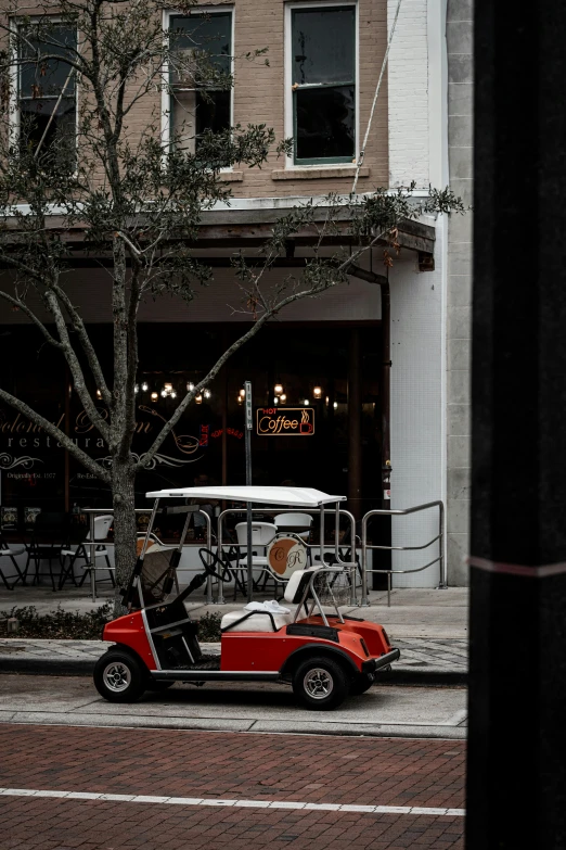 a buggy is parked in front of a cafe