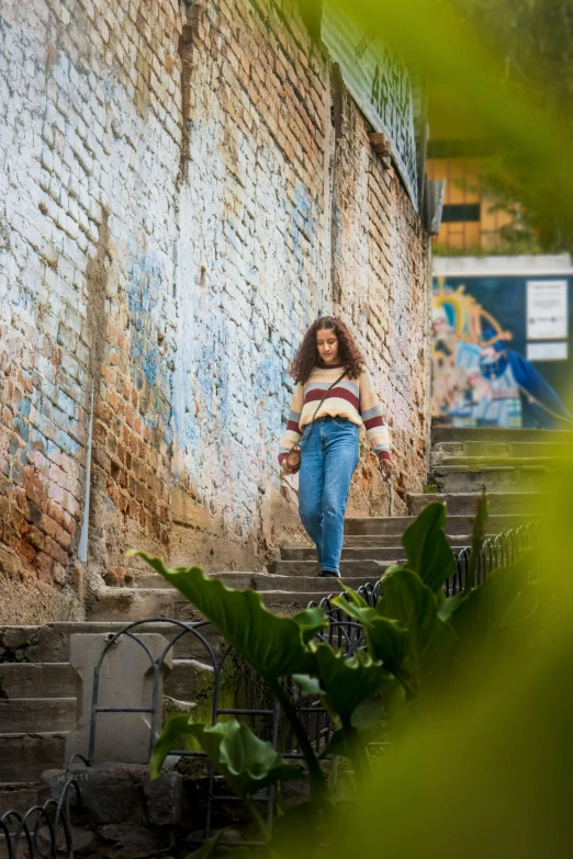 a woman walking down stairs outside of a building