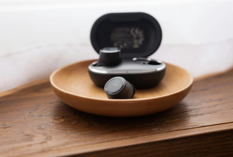 some electronics are sitting on a wooden tray