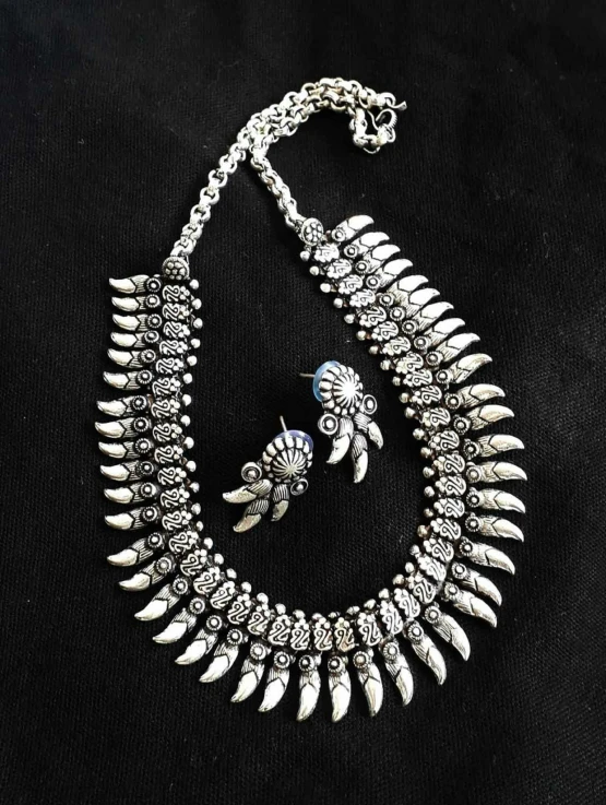 a necklace with spikes attached on a black cloth