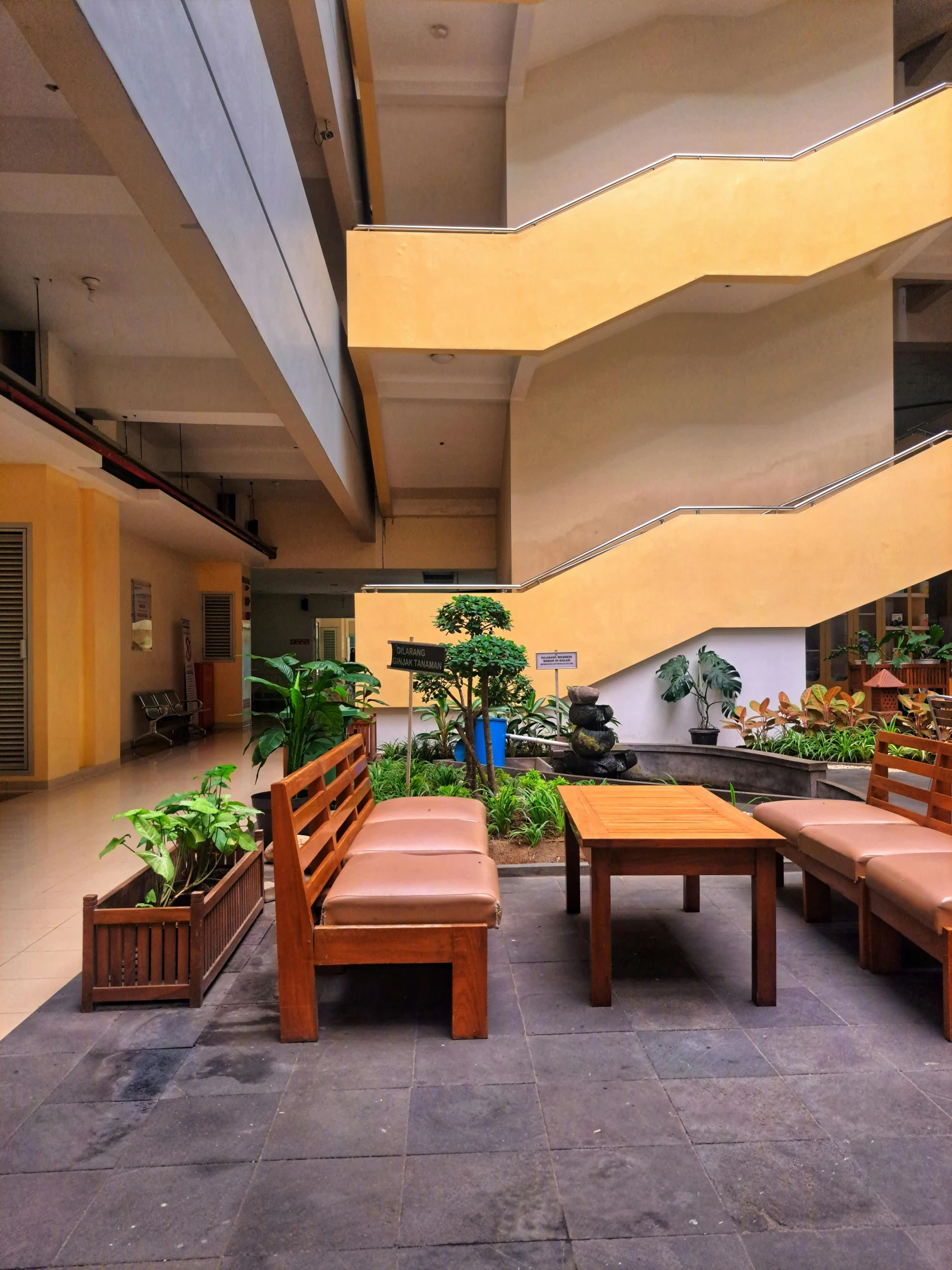 an outside patio with benches and planters in the corner