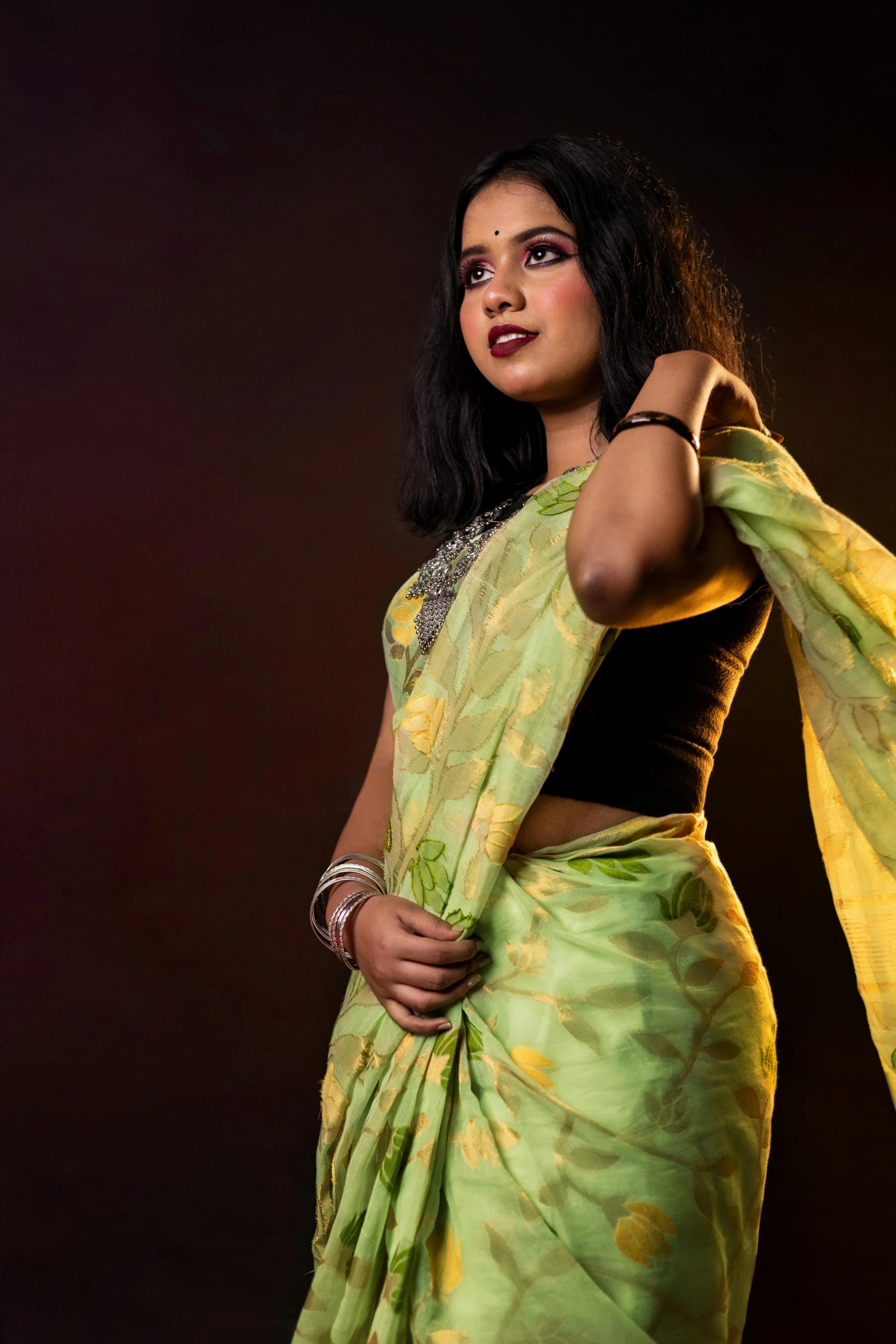 woman with an indian sari holding her hand out