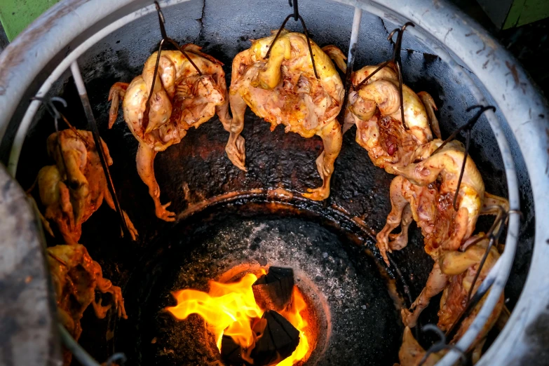 a bbq grill with many food being cooked