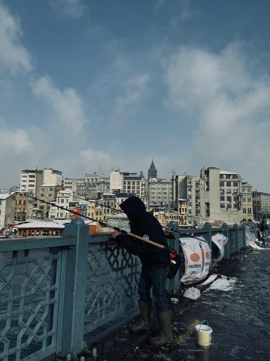 a man is standing on the side of a bridge