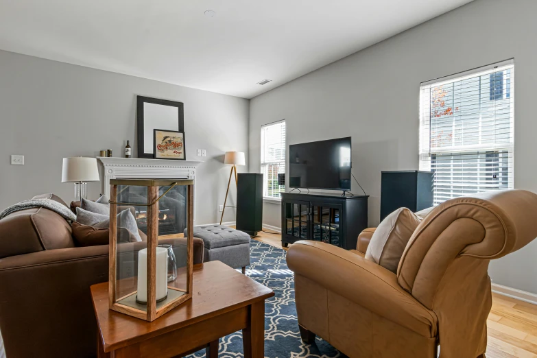 this is a clean living room with brown couches