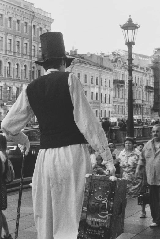 a man with a cane carrying luggage as others look on