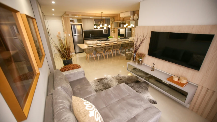 a modern living room filled with furniture and a flat screen tv