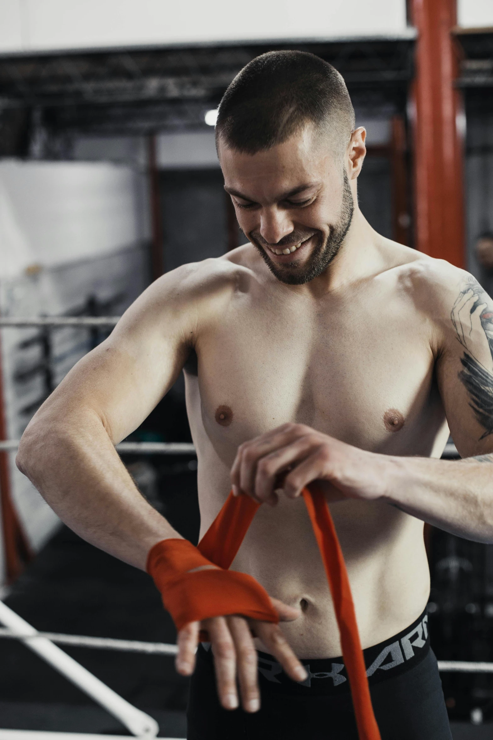 a shirtless male boxer is tying his underwear