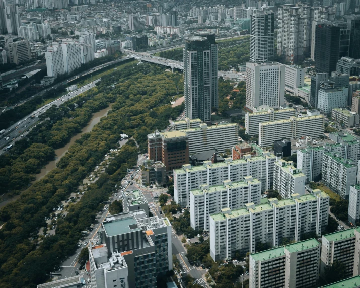 an aerial view of many buildings with green tops