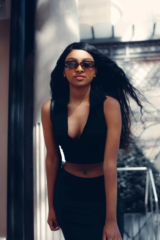 a beautiful young black woman wearing sunglasses and dress