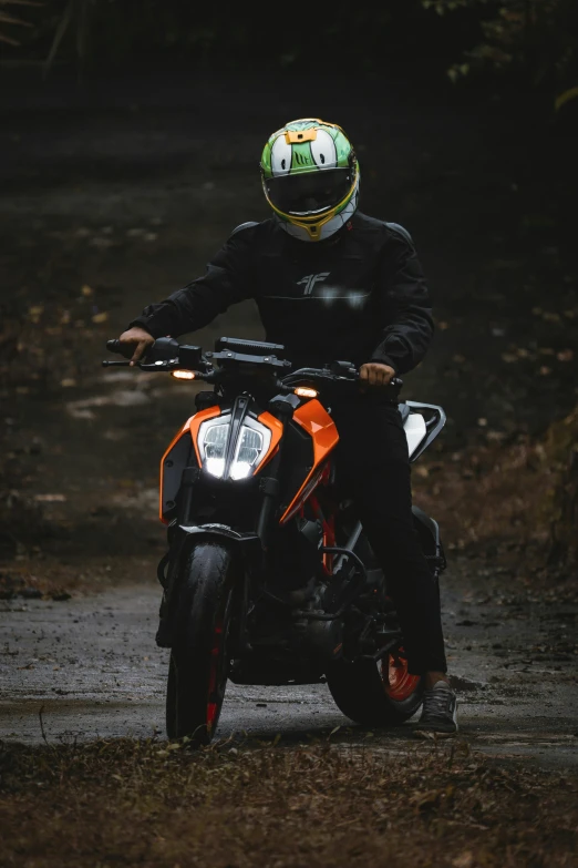 the man is riding his motorcycle on the trail