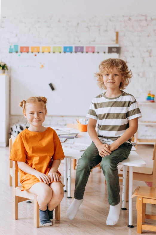 two children sitting in a wooden chair with the child sitting on top of the child