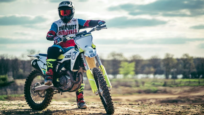 person in full dirt gear on a dirt bike