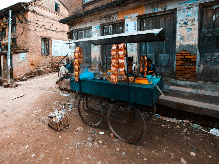 a bike is parked in front of a small food stand
