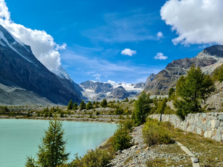 the view down the road from a mountain lake