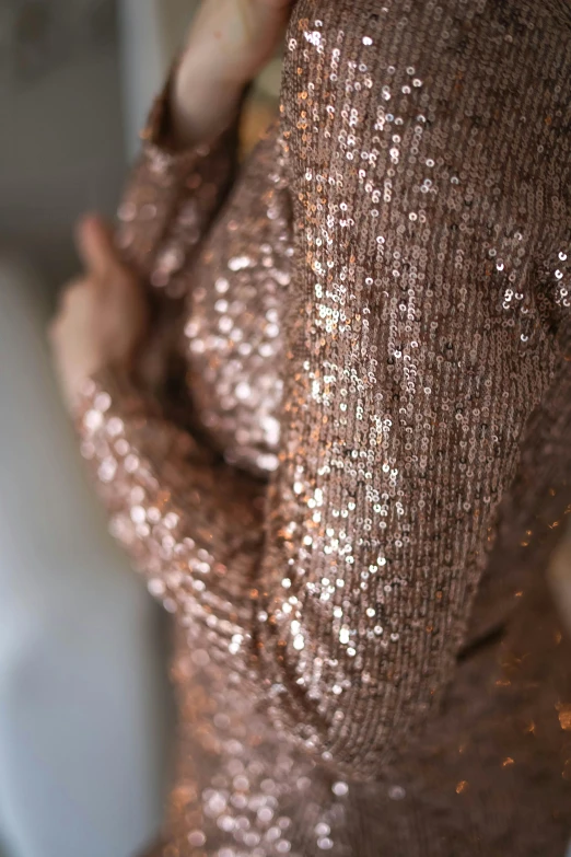 a gold sequinned blouse is on display