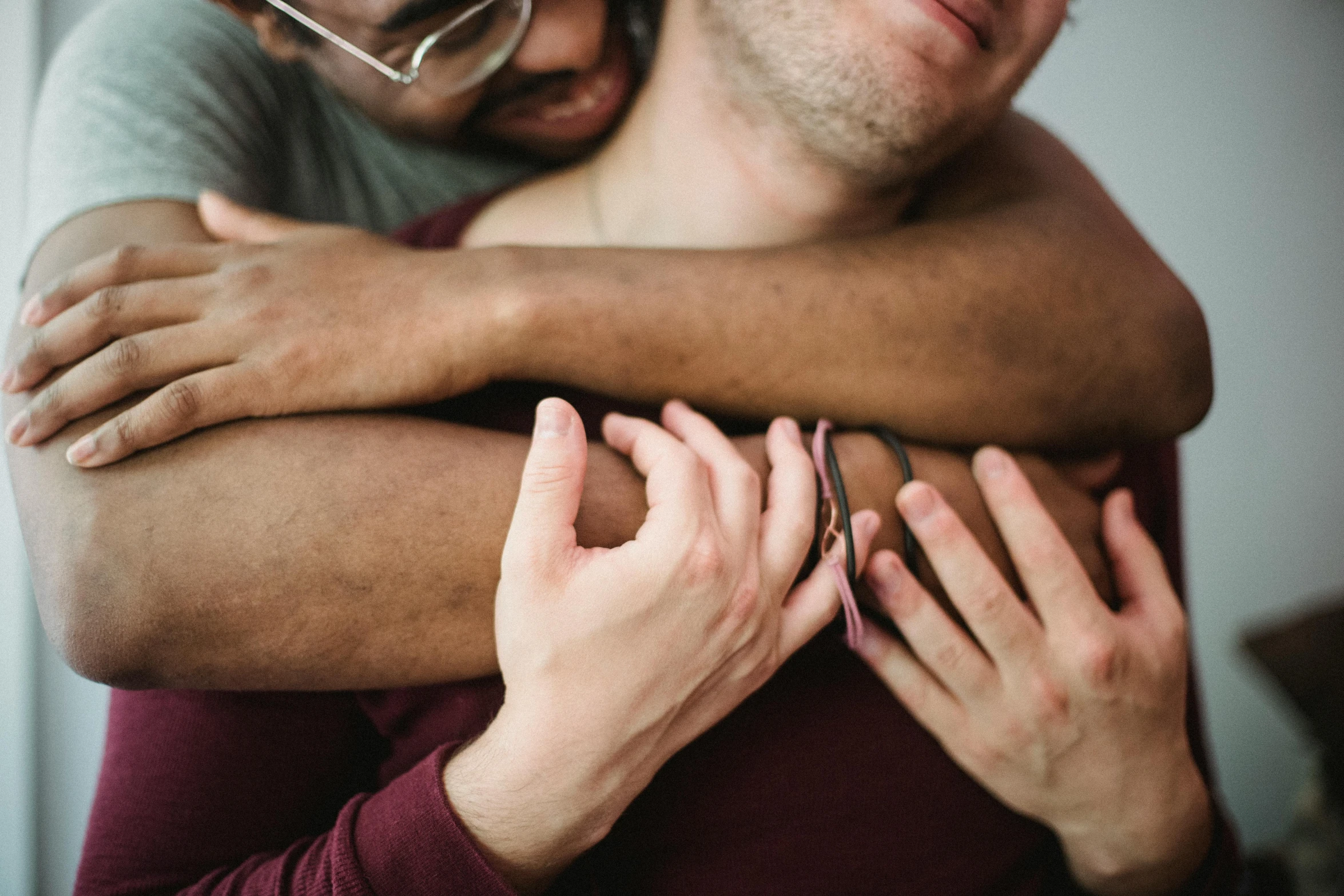 two people hugging each other with the man holding the woman in front