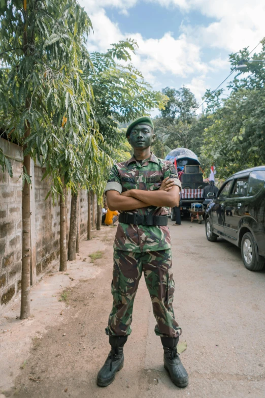 a soldier is standing in a green camouflage suit