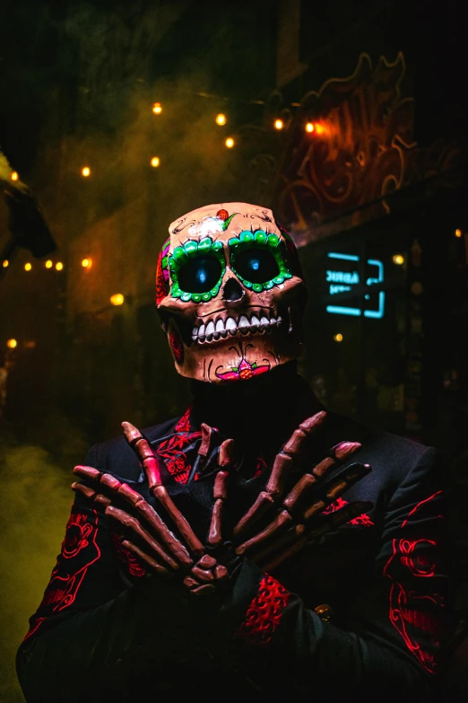 a man wearing skeleton makeup and holding his hands in front of him