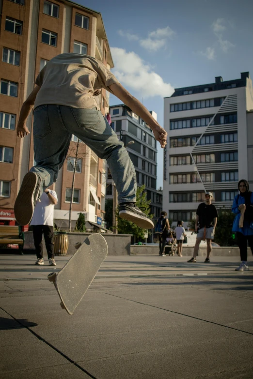 a skateboarder doing a trick in the city