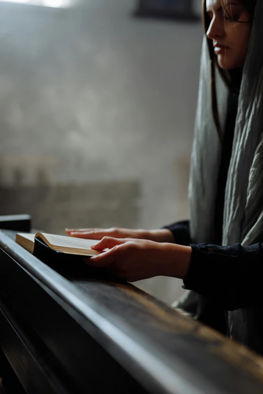 a woman is reading a book in front of her