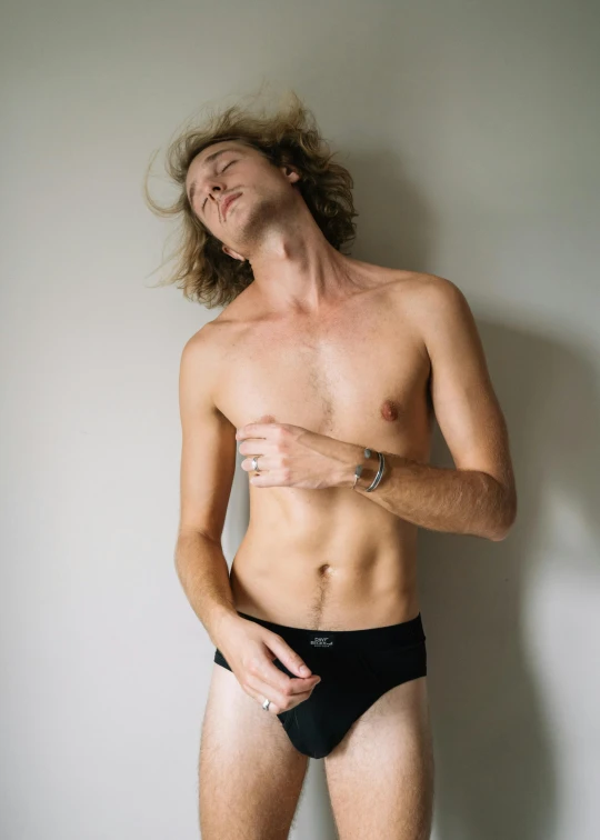 a man with  wearing black briefs