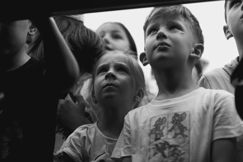 a group of children looking up at soing