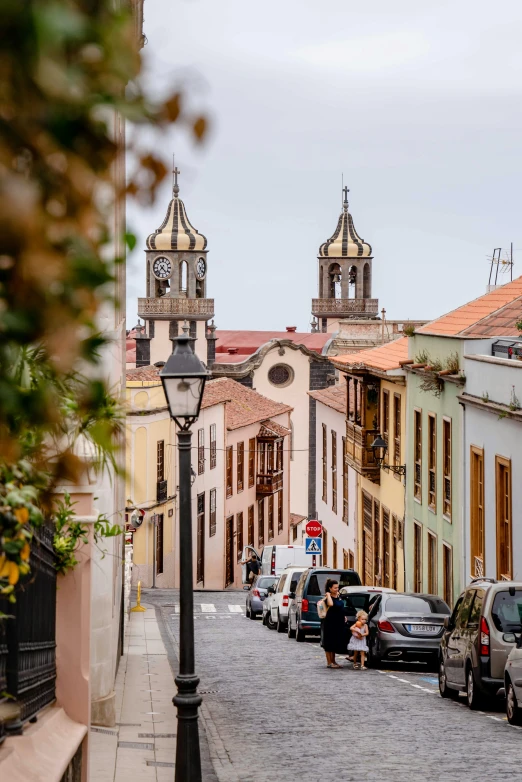 a cobble stone street lined with rows of historic buildings