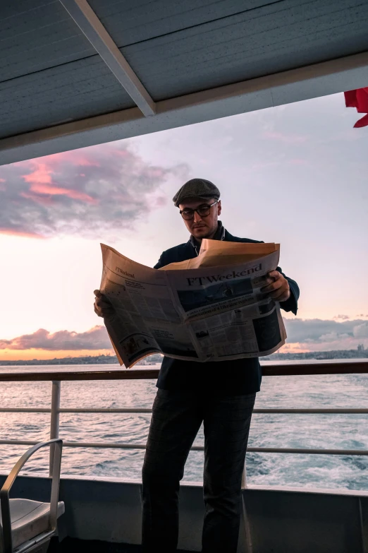 a man reading a newspaper on a boat