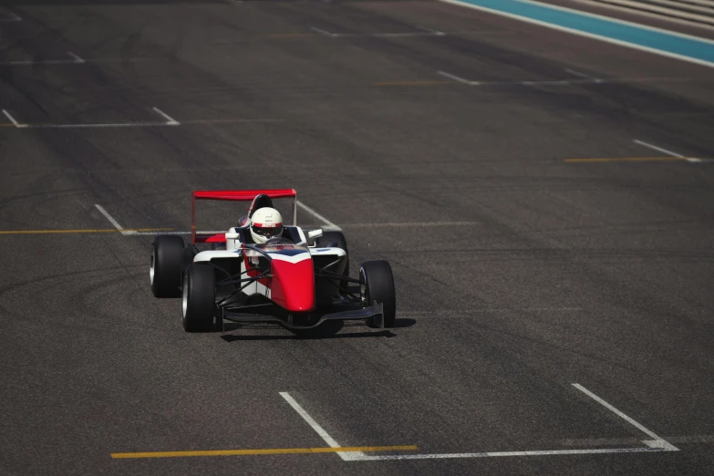 a car is racing on the track during the day