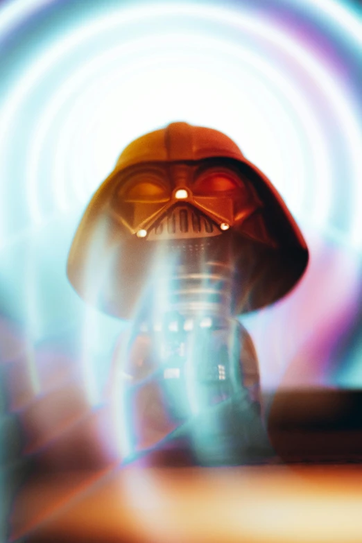 the head of darth vader with a blue light shining in the background