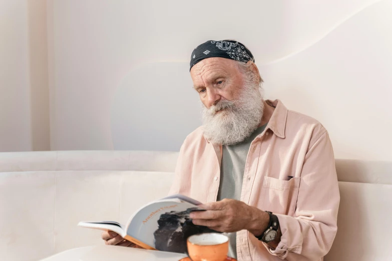 a man with a white beard reading a book