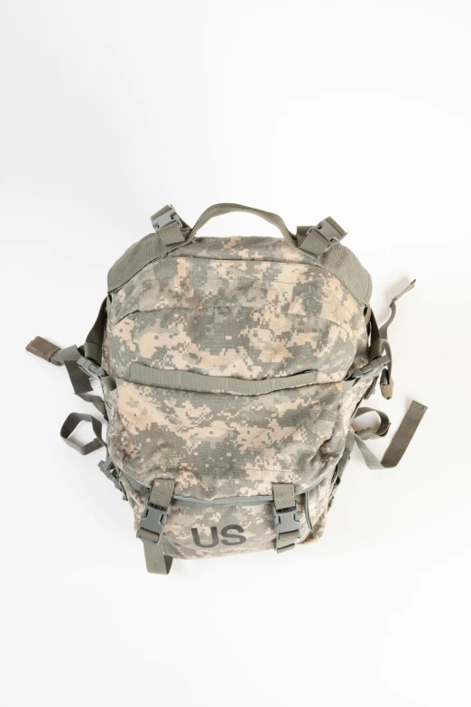 an old military backpack with three straps hanging from the bottom