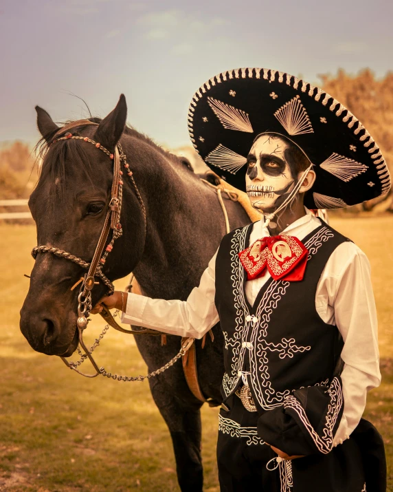 a skeleton wearing a mexican hat and tie stands next to a horse