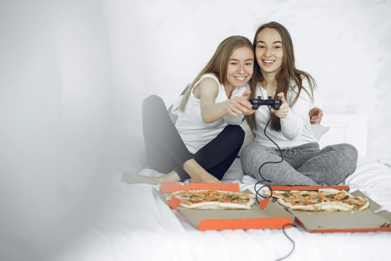 two beautiful young women taking pictures with a video camera