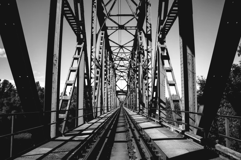 a train track going across a bridge on a dark day