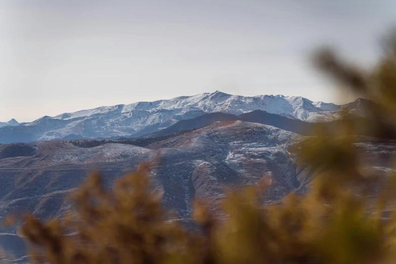 a large mountain on the horizon with snow on it