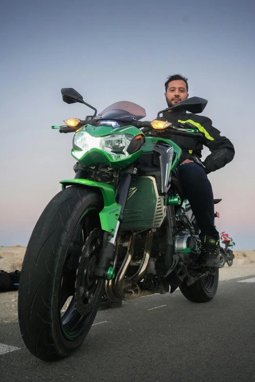 a man sitting on a motorcycle on the street