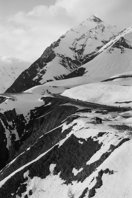 the snow - covered mountains are clear with white clouds