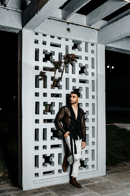 a man standing in front of a metal structure