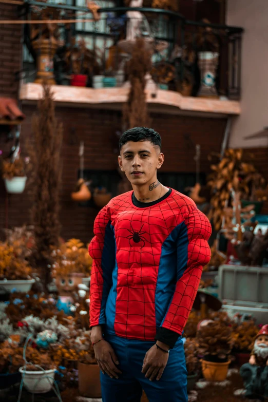 a man in a red and blue outfit standing with his hands on his hips