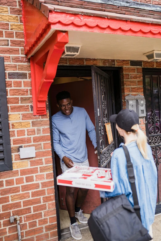 a person holding a box open near a door